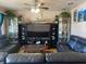 Living room boasts leather sofas, large TV, and wooden coffee table at 116 Kenova Dr, Indianapolis, IN 46227