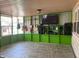 Screened porch with a TV, guitars and entertainment center at 116 Kenova Dr, Indianapolis, IN 46227
