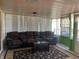 Relaxing sunroom featuring a brown leather sectional sofa and a coffee table at 116 Kenova Dr, Indianapolis, IN 46227