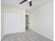Well-lit bedroom featuring gray carpet, ceiling fan and sliding closet doors at 1238 Orchard N Park, Carmel, IN 46280