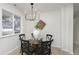 Bright dining area with glass-top table, black chairs, and a modern chandelier at 1238 Orchard N Park, Carmel, IN 46280