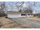 Newly renovated ranch home with white brick exterior, brown roof, and a spacious driveway at 1238 Orchard N Park, Carmel, IN 46280