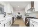 Modern kitchen with white cabinets, stainless steel appliances, and quartz countertops at 1238 Orchard N Park, Carmel, IN 46280