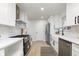 Modern white kitchen with stainless steel appliances and a farmhouse sink at 1238 Orchard N Park, Carmel, IN 46280
