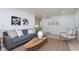Spacious living room with gray sofa, armchairs, and a neutral color palette at 1238 Orchard N Park, Carmel, IN 46280