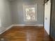 Bright bedroom featuring hardwood floors and barn door at 12625 Strawtown Ave, Noblesville, IN 46060