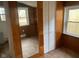 Charming bedroom with wood-paneled walls and a large mirror at 12625 Strawtown Ave, Noblesville, IN 46060