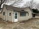 Tan house with green door and small window at 12625 Strawtown Ave, Noblesville, IN 46060