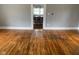 Hardwood floors and view into kitchen area at 12625 Strawtown Ave, Noblesville, IN 46060