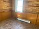 Spare room with wood-paneled walls, tile flooring, and a wall heater at 12625 Strawtown Ave, Noblesville, IN 46060