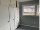 Storage room with white built-in cabinets and a window at 12625 Strawtown Ave, Noblesville, IN 46060