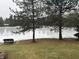 Frozen pond with a bench, peaceful backyard view at 16916 Olympus Blvd, Westfield, IN 46062