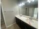 Double vanity bathroom with dark brown cabinets and a large mirror at 17389 Dallington St, Westfield, IN 46074