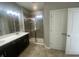 Modern bathroom with double vanity, shower, and dark brown cabinets at 17389 Dallington St, Westfield, IN 46074