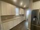 White kitchen cabinets, granite countertops, and stainless steel appliances at 17389 Dallington St, Westfield, IN 46074