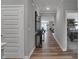Modern hallway with wood-look floors and view into living area at 19509 Mcbee Ave, Westfield, IN 46074