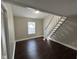 Bedroom with dark hardwood floors and stairway to loft at 2009 N Ball Ave, Muncie, IN 47304