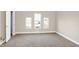 Simple bedroom with three windows and carpet flooring at 2215 Brookside Ave, Indianapolis, IN 46218