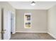 Spacious bedroom featuring neutral walls and carpet, plus a window offering a view at 2215 Brookside Ave, Indianapolis, IN 46218