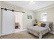 Cozy bedroom with carpeted floors and a barn door leading to the bathroom at 2215 Brookside Ave, Indianapolis, IN 46218
