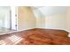 Well-lit bedroom with hardwood floors and a door at 2502 N Harding N St, Indianapolis, IN 46208