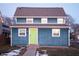 Two-story blue house with white trim, lime green door, and a gray roof at 2502 N Harding N St, Indianapolis, IN 46208