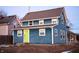 Two-story blue house with white trim, lime green door, and side porch at 2502 N Harding N St, Indianapolis, IN 46208