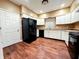 Modern kitchen with white cabinets and black appliances at 2502 N Harding N St, Indianapolis, IN 46208