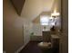 Traditional bathroom includes a toilet, sink, and tub with wood look flooring at 30 N Muessing St, Indianapolis, IN 46229