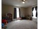 Bright bedroom with neutral carpet and curtains, plus ample space for play at 30 N Muessing St, Indianapolis, IN 46229