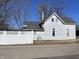 White house with a gray roof and a fenced backyard at 30 N Muessing St, Indianapolis, IN 46229