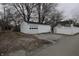 A detached garage with a single door and a gravel driveway at 30 N Muessing St, Indianapolis, IN 46229