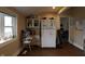 Cozy kitchen with lots of light and view of a dining area featuring hardwood floors and white cabinetry at 30 N Muessing St, Indianapolis, IN 46229