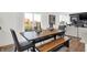 Bright dining area with wooden table, bench, and view to backyard at 3608 Planck Cir, Danville, IN 46122
