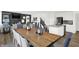 Open concept dining room with a long wooden table and access to the living room and kitchen at 3608 Planck Cir, Danville, IN 46122
