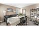 This dining room features six chairs around a wooden table, a window, and carpet flooring at 366 Rocky Rd, Greenfield, IN 46140