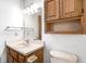 A bathroom featuring a wood vanity, mirror, lighting fixture, and toilet at 368 Seabreeze Cir, Avon, IN 46123