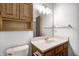 Bathroom showcasing wood vanity with cabinet, white countertop and sink, and decorative light fixture at 368 Seabreeze Cir, Avon, IN 46123
