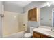 Bathroom featuring a tub and shower combination with a wood vanity and matching wood cabinet at 368 Seabreeze Cir, Avon, IN 46123