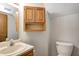 Small half bathroom features a toilet, and a sink with an updated faucet, and wooden cabinets at 368 Seabreeze Cir, Avon, IN 46123
