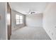 A bright, neutral bedroom with carpet, a ceiling fan, and a large window at 368 Seabreeze Cir, Avon, IN 46123