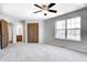 Neutral bedroom with carpet, ceiling fan, large window, and closet at 368 Seabreeze Cir, Avon, IN 46123
