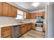 Well-lit kitchen features wood cabinetry, modern stainless steel appliances, and vinyl flooring at 368 Seabreeze Cir, Avon, IN 46123