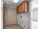 A tidy laundry room with tiled floors and built-in storage cabinets, ready for appliances at 368 Seabreeze Cir, Avon, IN 46123