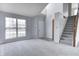 Bright living room featuring large window, neutral carpet, fresh paint, and stairway to the upper level at 368 Seabreeze Cir, Avon, IN 46123