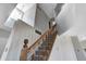 Staircase with wooden banister leads to second level with skylight, freshly painted walls and neutral carpet at 368 Seabreeze Cir, Avon, IN 46123