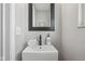 Small bathroom with a pedestal sink and mirror at 4155 Senour Rd, Indianapolis, IN 46239
