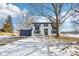 Two-story house with white brick, navy blue accents, and a tree in the front yard at 4155 Senour Rd, Indianapolis, IN 46239