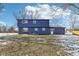 Rear view of a two-story blue house with yard at 4155 Senour Rd, Indianapolis, IN 46239