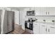 Modern kitchen with stainless steel appliances and white cabinets at 4155 Senour Rd, Indianapolis, IN 46239